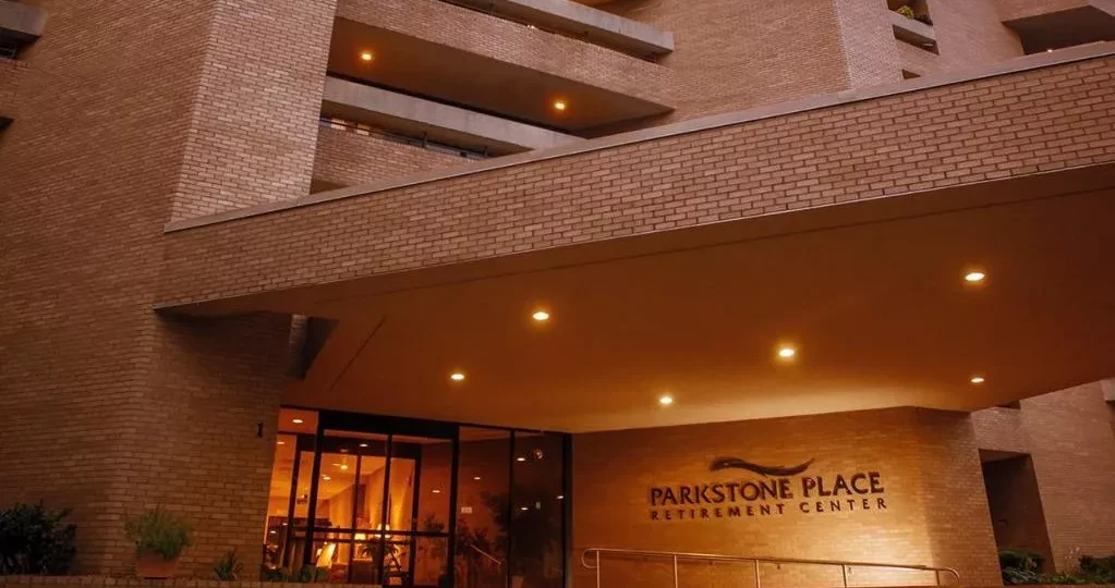 Entrance of Parkstone Place Retirement Center at night.