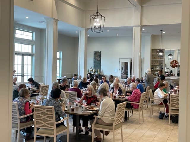 Seniors dining in a bright, spacious restaurant.